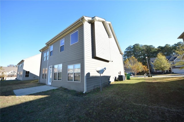 rear view of property with a yard