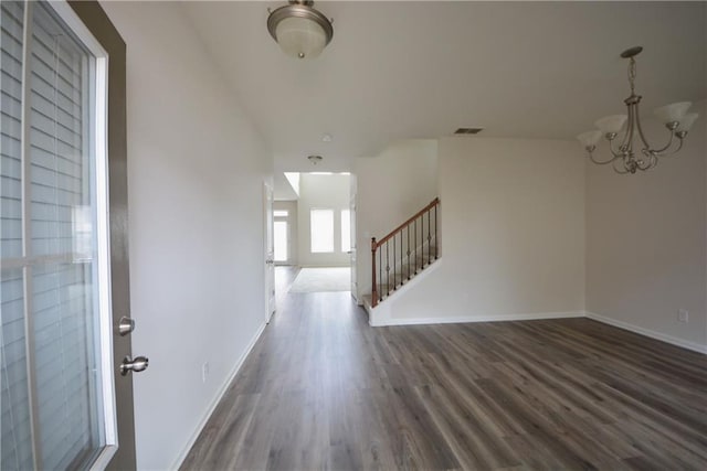 entryway featuring visible vents, baseboards, stairway, an inviting chandelier, and dark wood-style floors