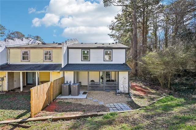 rear view of house with a patio area, fence, and central air condition unit