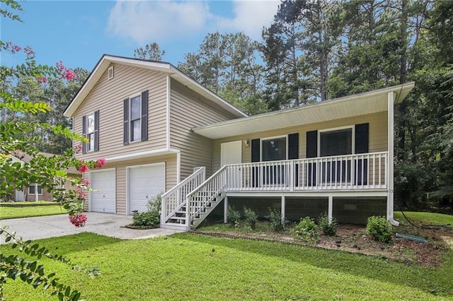 tri-level home with a garage, a front yard, and covered porch