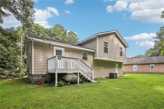 back of property featuring a lawn, central air condition unit, and a wooden deck