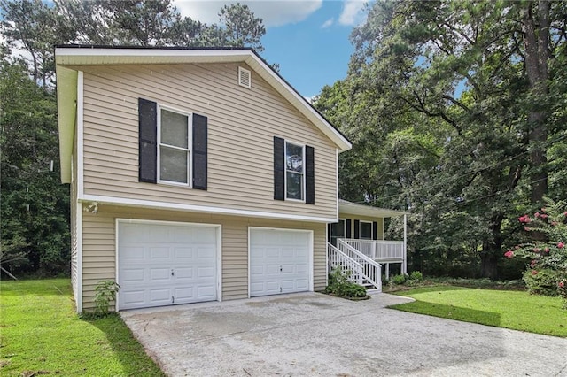 view of front of home with a front lawn, a garage, and covered porch