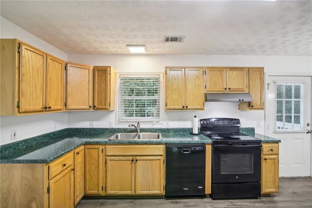 kitchen with black appliances, sink, a textured ceiling, and hardwood / wood-style floors