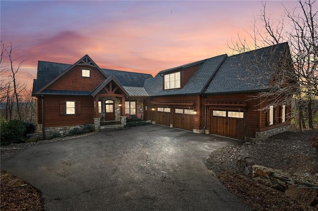 view of front of house with a garage and aphalt driveway