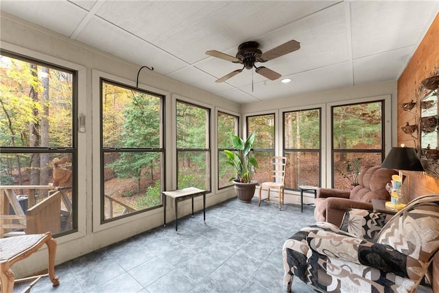 sunroom / solarium featuring ceiling fan