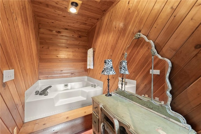 bathroom with a washtub, wood ceiling, and wood walls