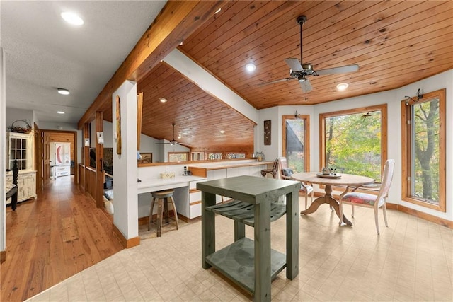 dining area with beam ceiling, wood ceiling, and ceiling fan