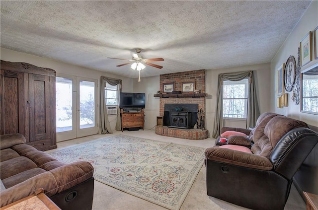 90 Wiley Dr, Douglasville, GA 30134 - carpeted living room featuring a textured ceiling, a ceiling fan, a fireplace, and cooling unit