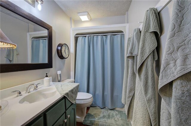 90 Wiley Dr, Douglasville, GA 30134 - full bathroom featuring vanity, toilet, a textured ceiling, and a shower with shower curtain