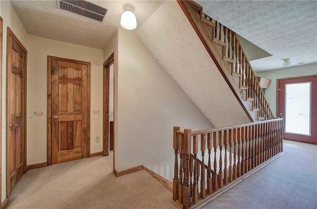 90 Wiley Dr, Douglasville, GA 30134 - corridor featuring carpet flooring, a textured ceiling, baseboards, and an upstairs landing