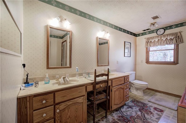 90 Wiley Dr, Douglasville, GA 30134 - full bath featuring double vanity, toilet, wallpapered walls, and a textured ceiling