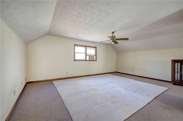 90 Wiley Dr, Douglasville, GA 30134 - additional living space featuring carpet, lofted ceiling, a ceiling fan, baseboards, and a textured ceiling