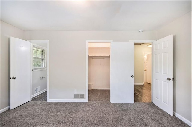 3436 Dodson Ter, Atlanta, GA 30344 - unfurnished bedroom with carpet flooring, a walk in closet, baseboards, and a closet