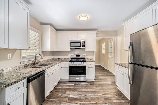 3436 Dodson Ter, Atlanta, GA 30344 - kitchen featuring stainless steel appliances, plenty of natural light, a sink, and dark wood-style floors