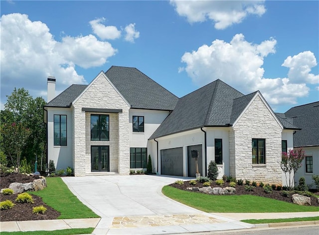 view of front of property with a front lawn and a garage