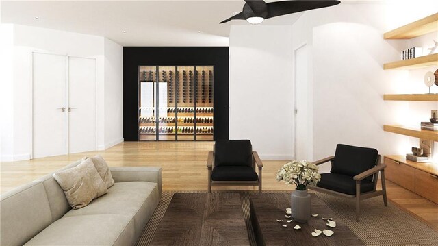 living room with ceiling fan and light hardwood / wood-style flooring