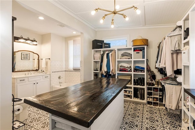527 Main St, Suwanee, GA 30024 - spacious closet featuring a chandelier and tile patterned flooring