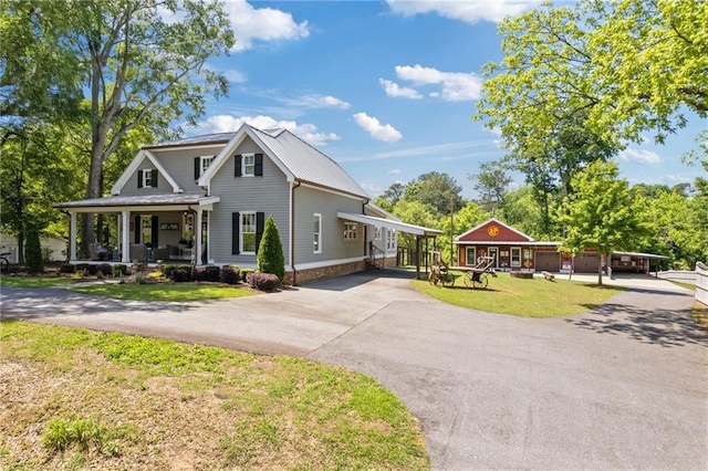 527 Main St, Suwanee, GA 30024 - view of front of home featuring driveway, a porch, a front yard, a metal roof, and a carport