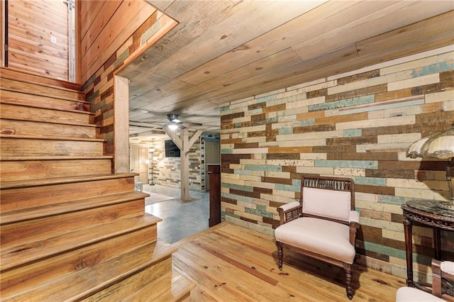 527 Main St, Suwanee, GA 30024 - living area with wood walls, stairway, wood ceiling, and finished concrete floors