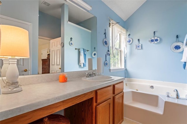 bathroom with lofted ceiling, vanity, and a washtub