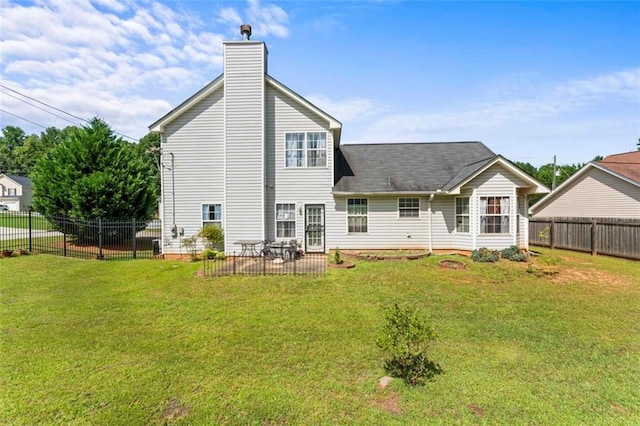 back of house with a lawn