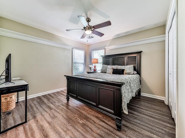 bedroom featuring visible vents, dark wood finished floors, baseboards, and ceiling fan