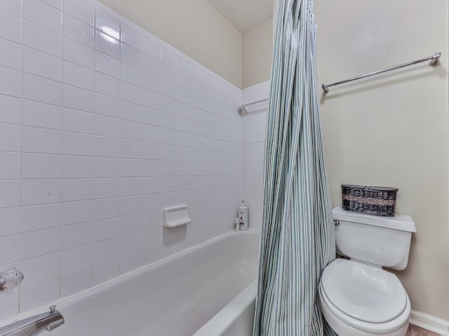 full bath featuring toilet and shower / bath combo with shower curtain