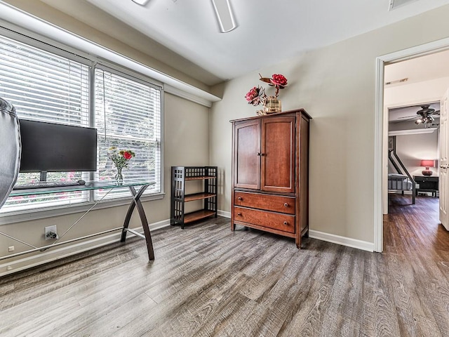 home office featuring ceiling fan, wood finished floors, and baseboards