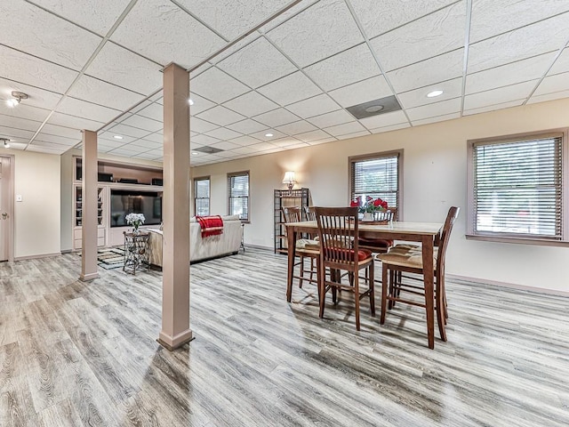 dining area featuring a paneled ceiling, a wealth of natural light, and wood finished floors