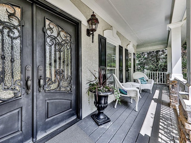 doorway to property featuring stucco siding