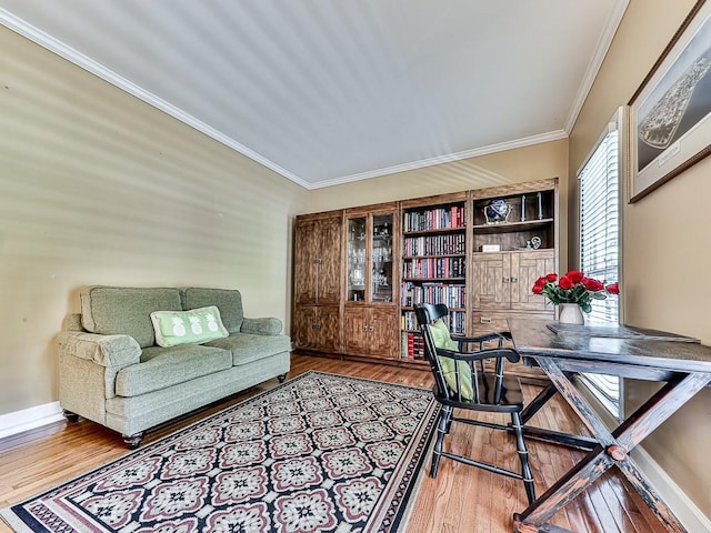 home office featuring baseboards, ornamental molding, and wood finished floors