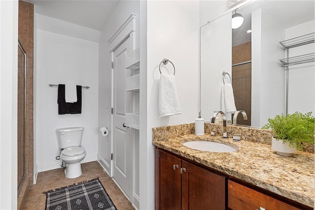 full bathroom with toilet, a stall shower, vanity, and tile patterned flooring