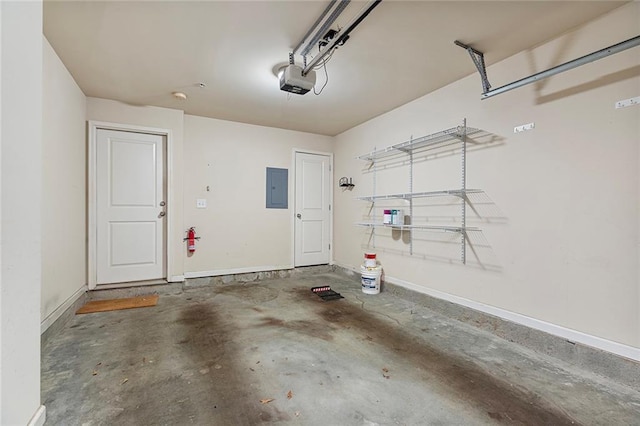 garage featuring electric panel, a garage door opener, and baseboards