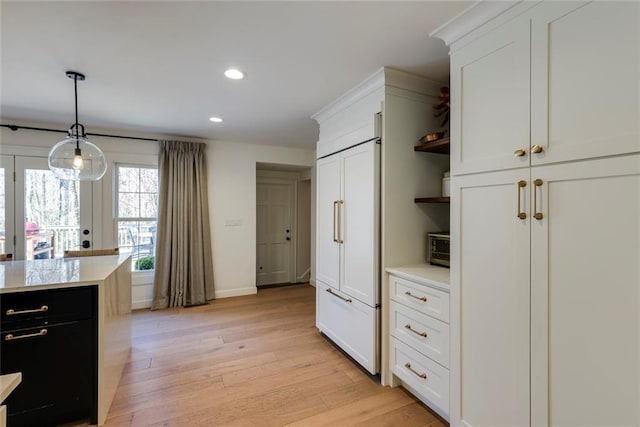 kitchen featuring recessed lighting, light countertops, hanging light fixtures, open shelves, and light wood finished floors