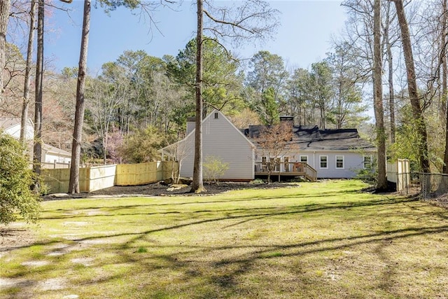 view of yard featuring a deck and fence