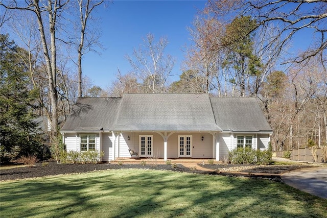 view of front of home with french doors and a front lawn