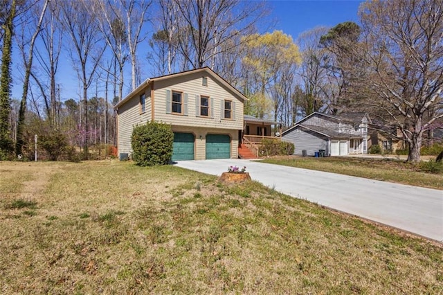 split level home featuring driveway, a garage, and a front lawn