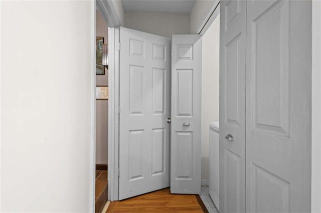 corridor featuring light wood finished floors