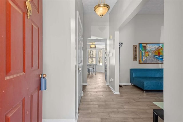 foyer entrance with baseboards and light wood finished floors