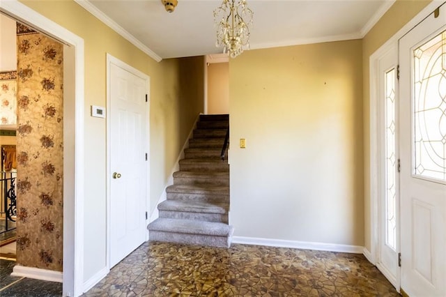 entrance foyer featuring ornamental molding, baseboards, stairway, and a notable chandelier
