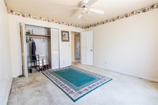 bedroom with carpet flooring, a closet, baseboards, and a ceiling fan