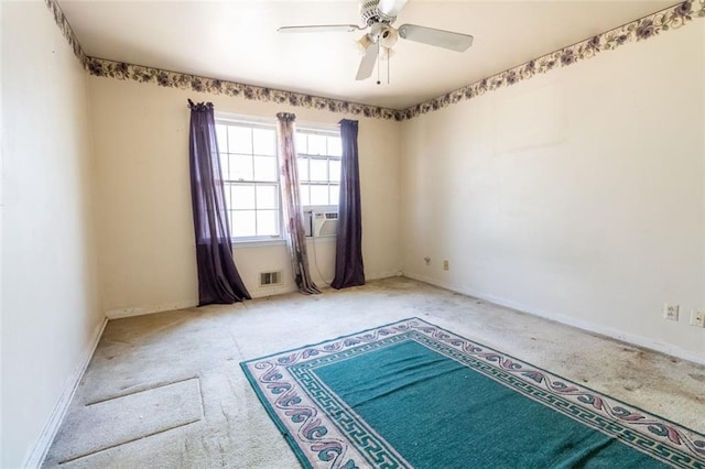spare room featuring visible vents, baseboards, a ceiling fan, and carpet floors