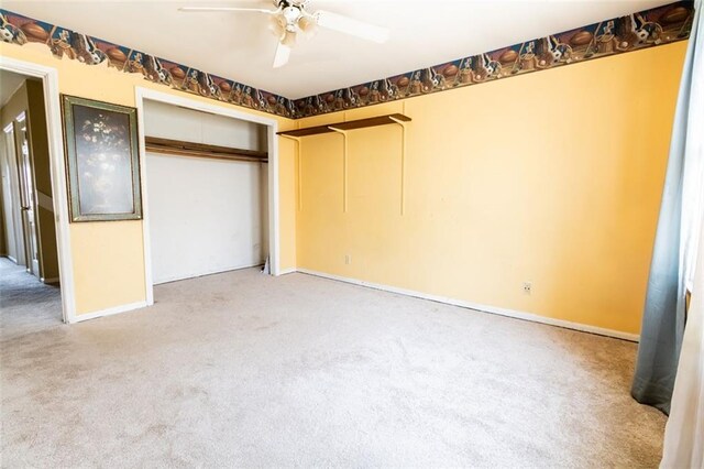 unfurnished bedroom with a closet, baseboards, a ceiling fan, and carpet