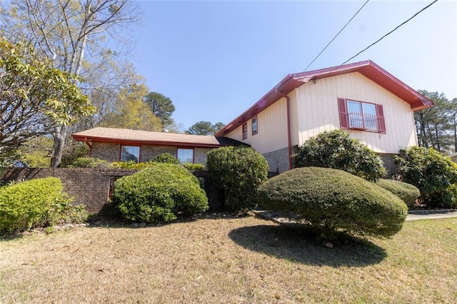 view of home's exterior featuring a lawn