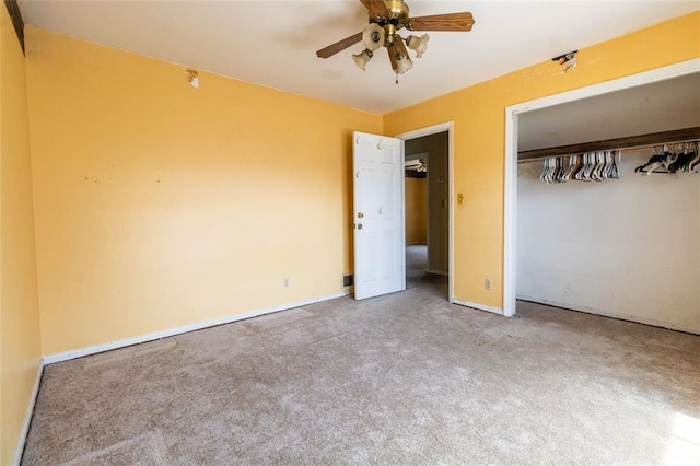 unfurnished bedroom featuring carpet flooring, a closet, baseboards, and a ceiling fan