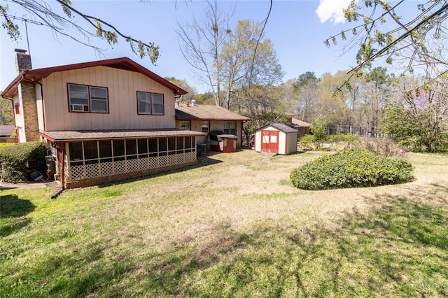 exterior space with a yard, an outdoor structure, a shed, and a chimney