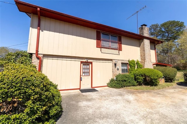 back of property with a chimney