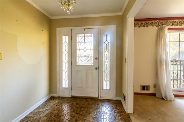 foyer featuring visible vents, baseboards, and crown molding