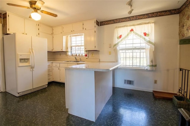 kitchen featuring white fridge with ice dispenser, white cabinetry, a ceiling fan, visible vents, and dark floors