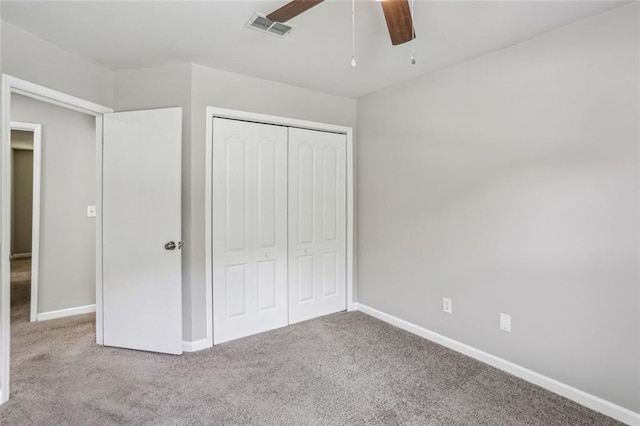 1050 Chapman Cir, Stone Mountain, GA 30088 - unfurnished bedroom featuring carpet floors, a closet, and a ceiling fan